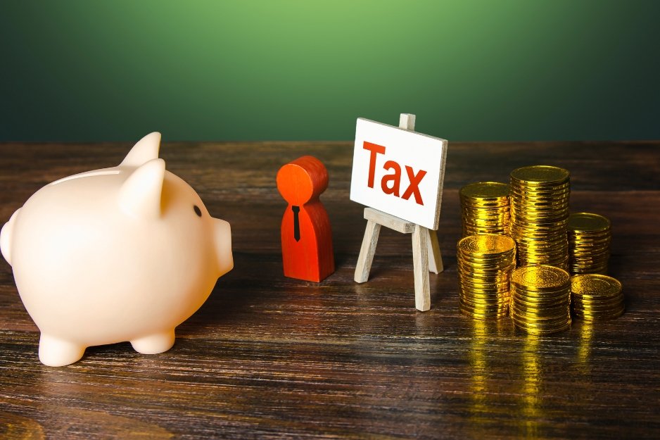 Tax preparation services concept with a piggy bank, tax advisor figure, tax sign, and stacked coins representing savings.